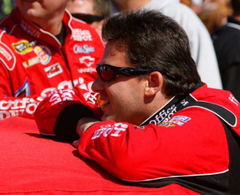 man in red racing suit