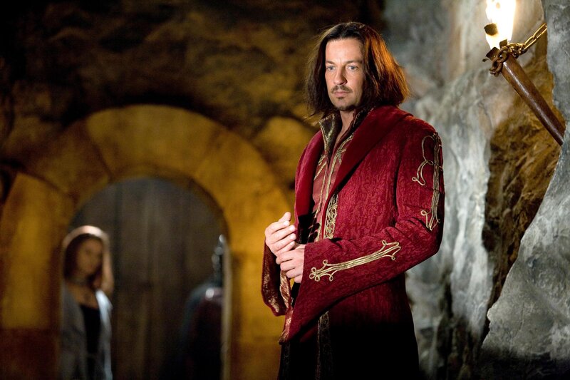 Man in red robe in dungeon