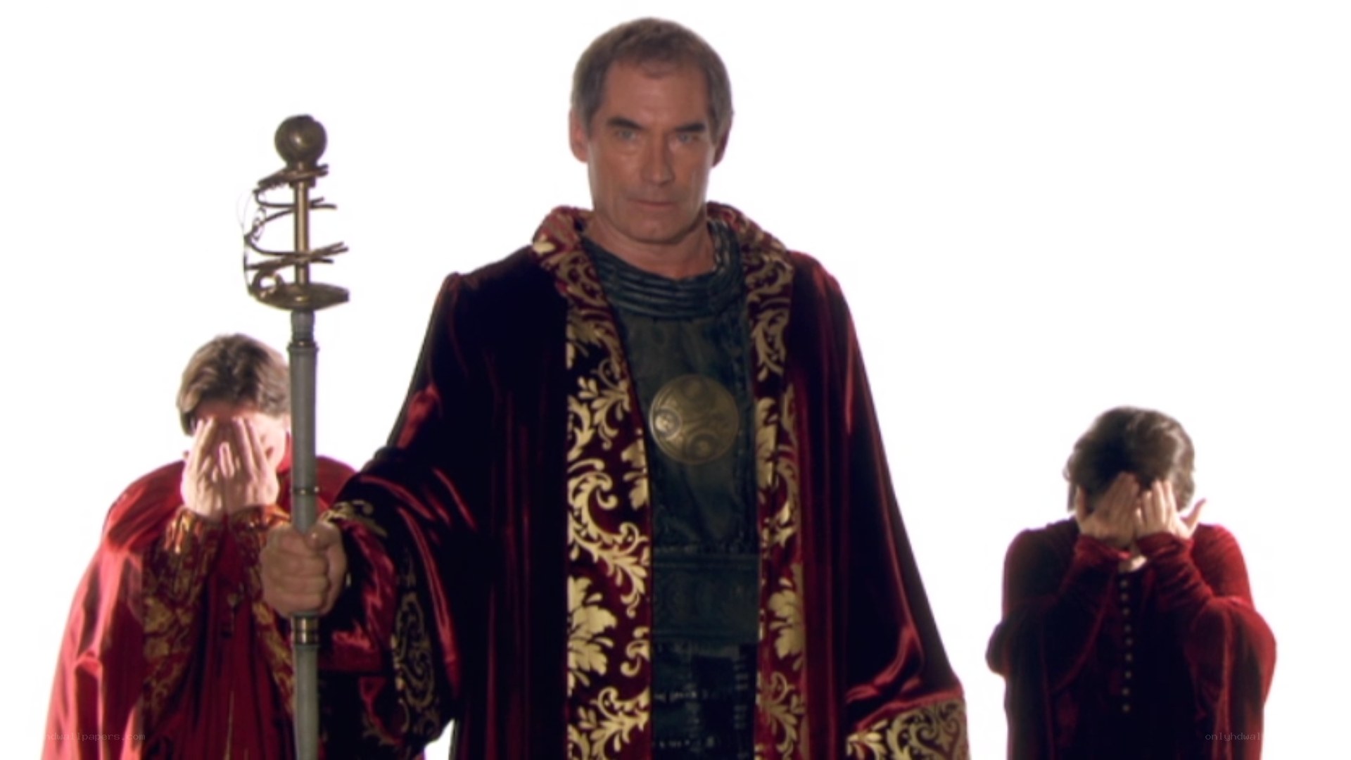 man in red robe with staff