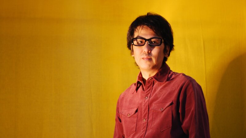 man in red shirt and glasses