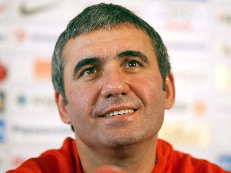 man in red shirt at press event