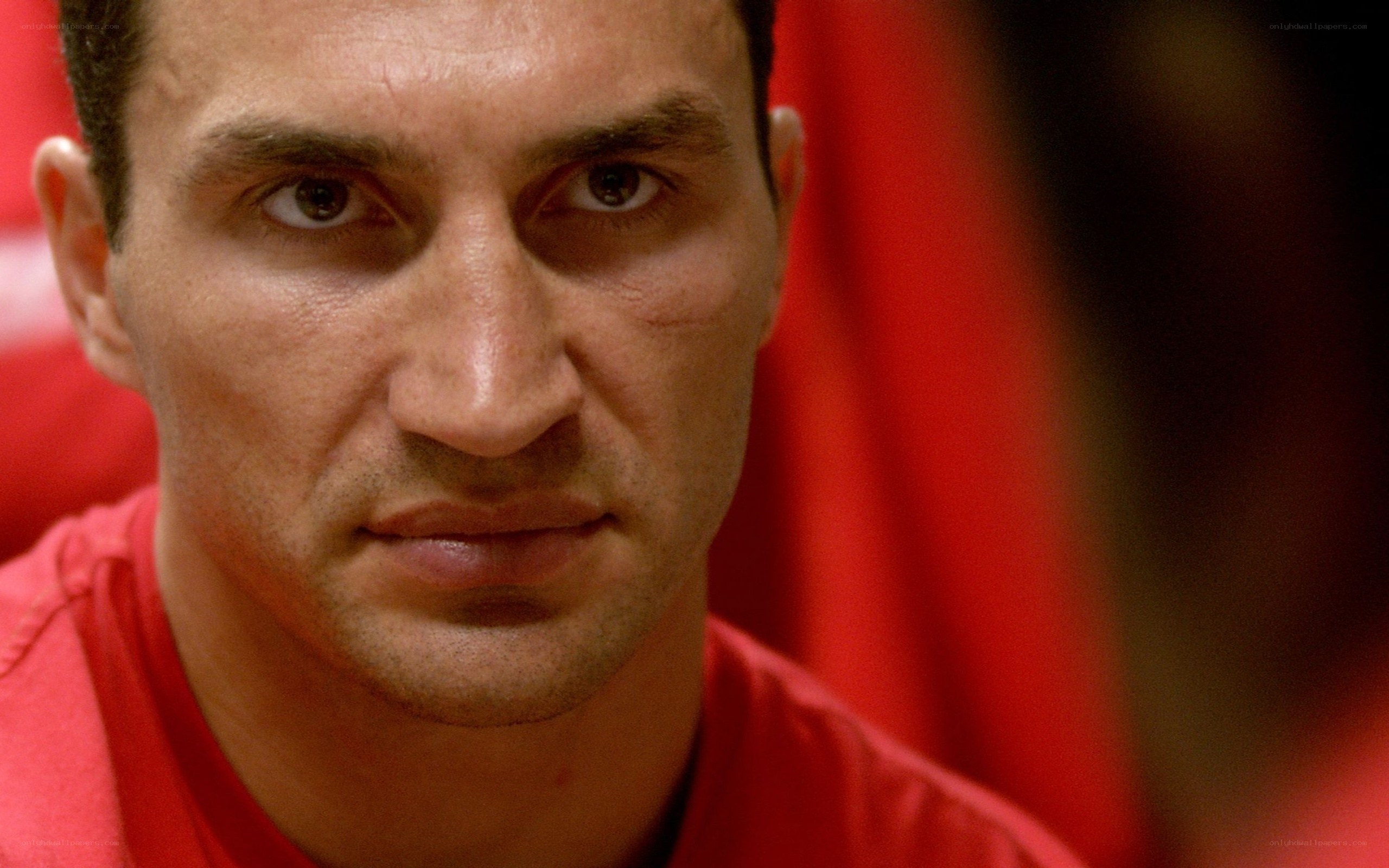 man in red shirt looking at camera