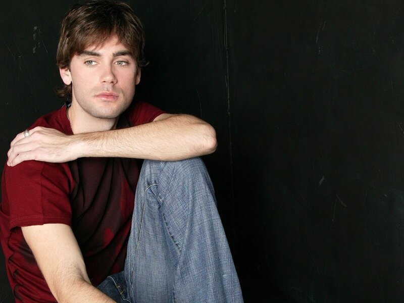 man in red shirt sitting