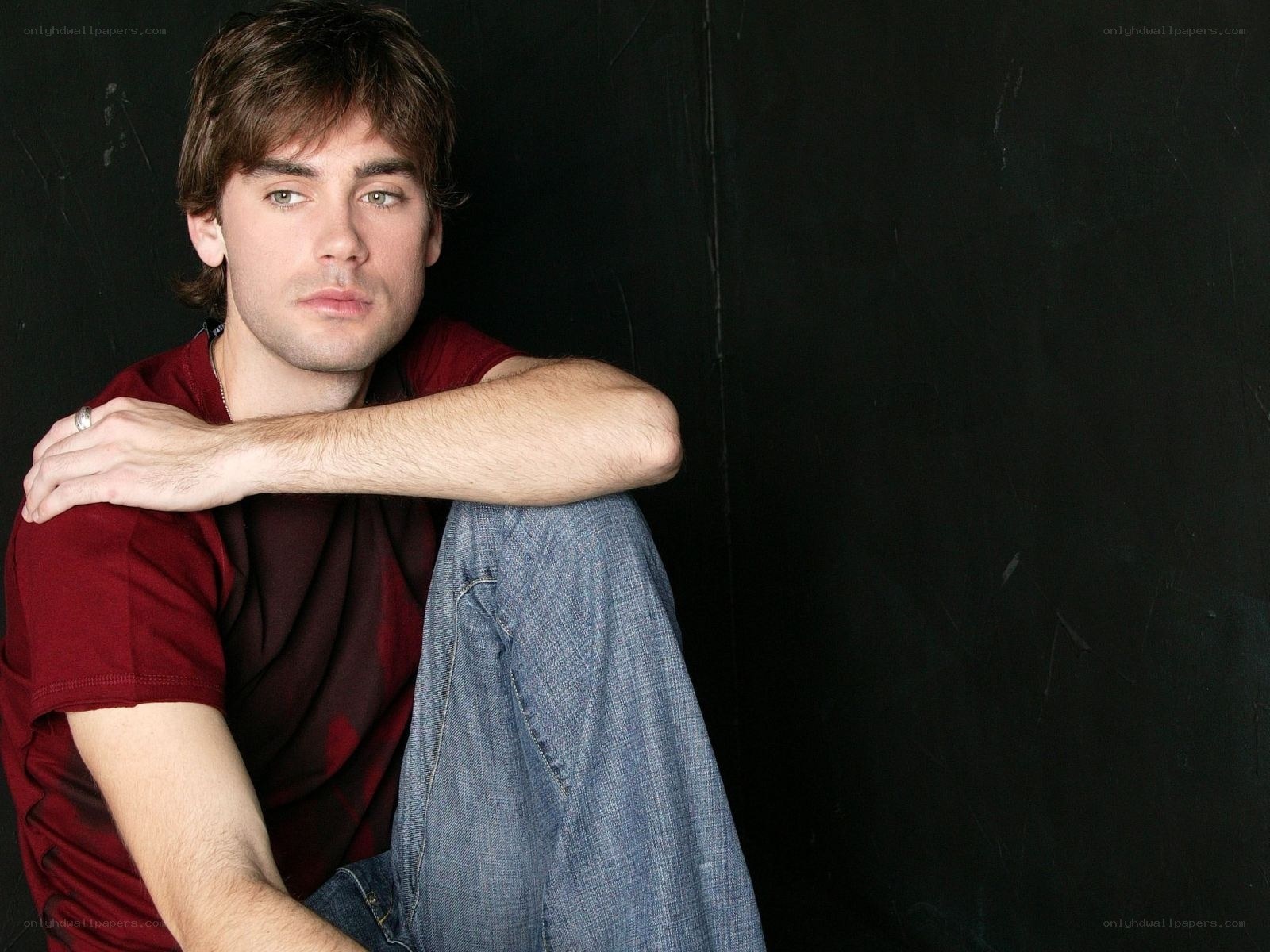 man in red shirt sitting