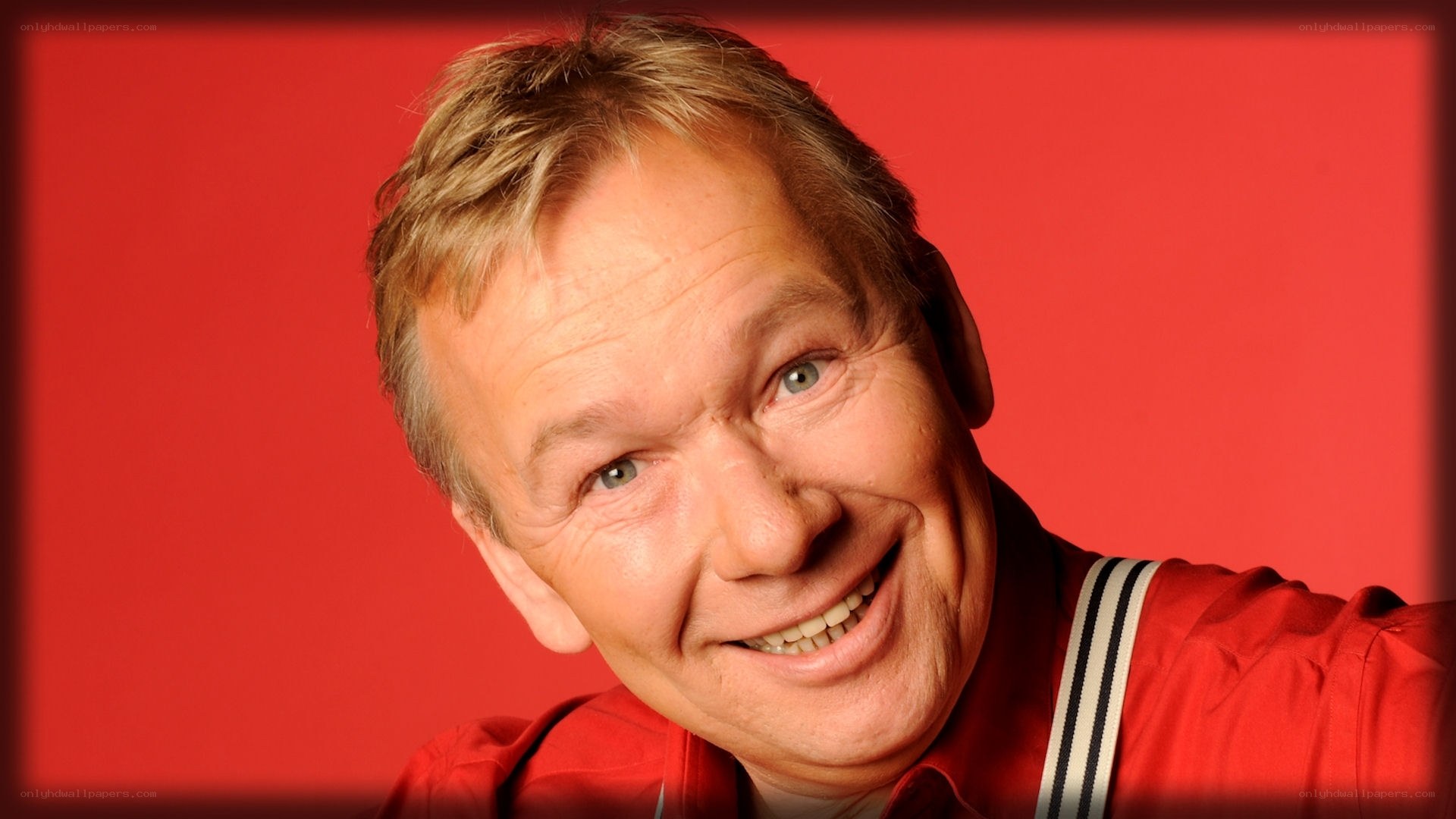 man in red shirt smiling