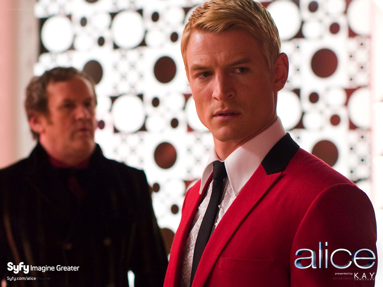 Man in red suit on set
