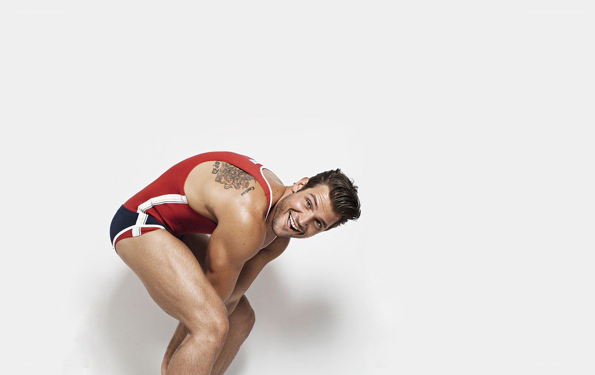 man in red swimsuit smiling