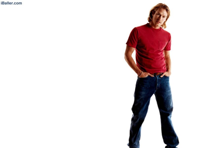 man in red t-shirt and jeans