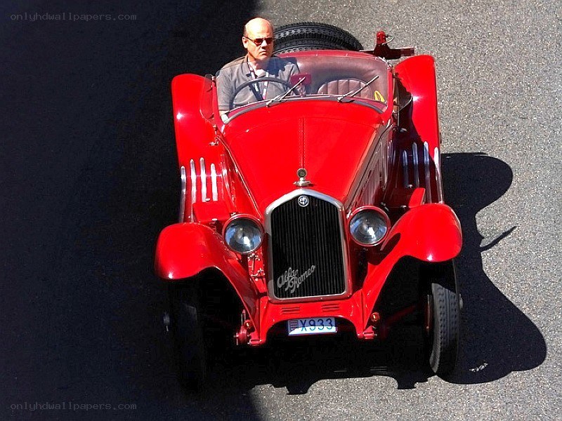Man in red vintage car