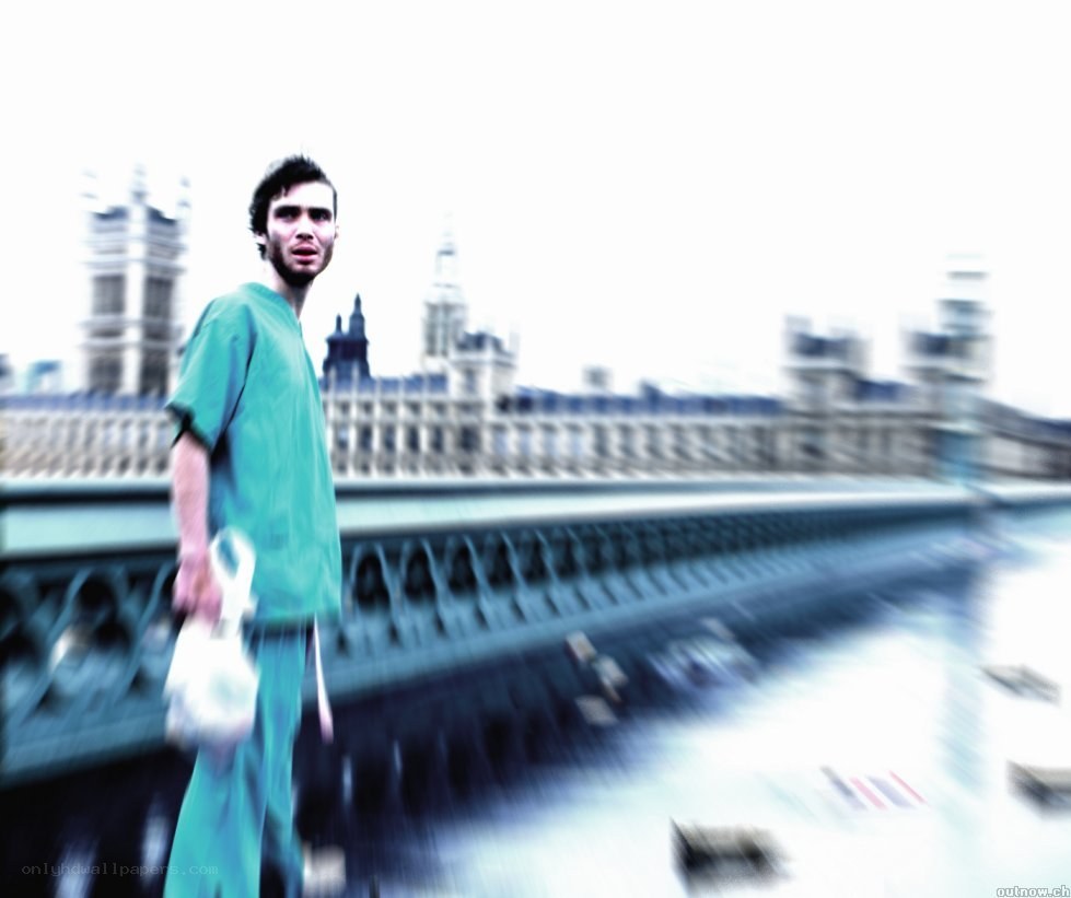 Man in scrubs on bridge