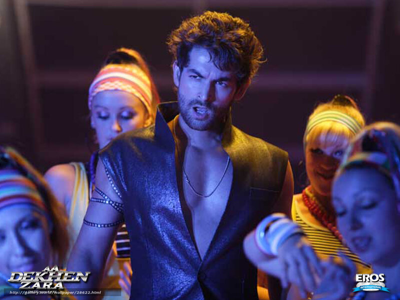 Man in shiny vest with dancers