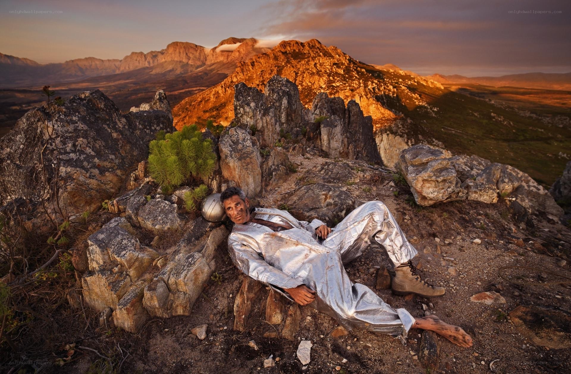 Man in silver suit on mountain