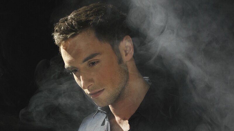 man in smoke with contemplative expression