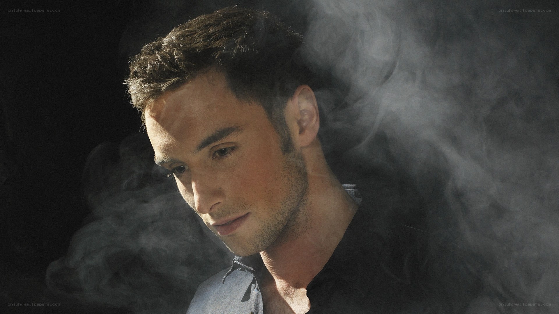 man in smoke with contemplative expression