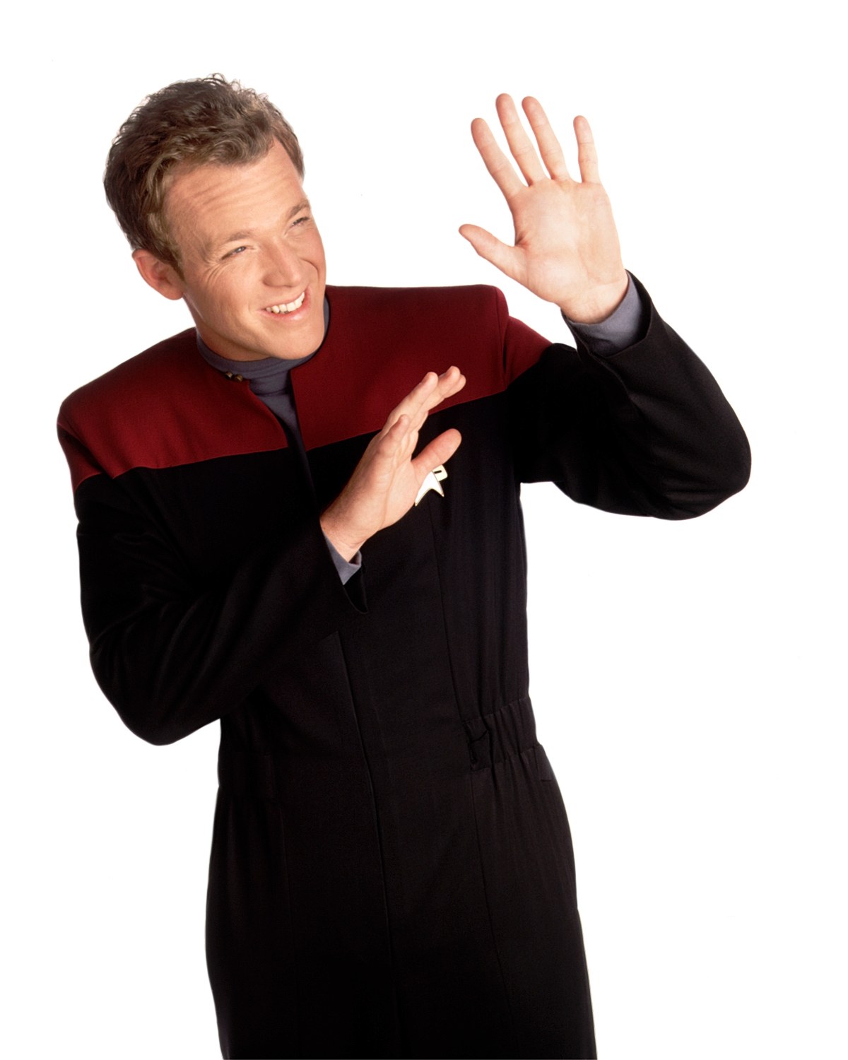 man in star trek uniform waving