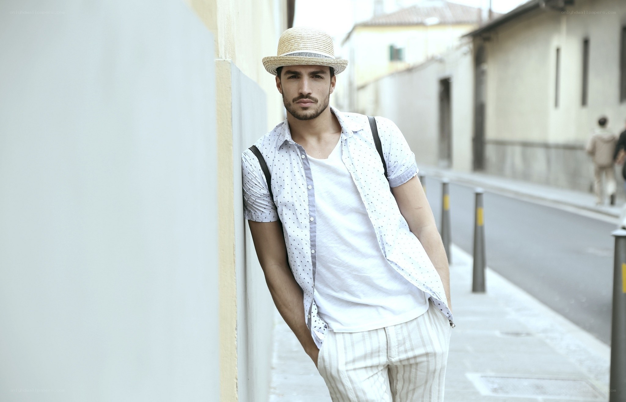 man in straw hat on street
