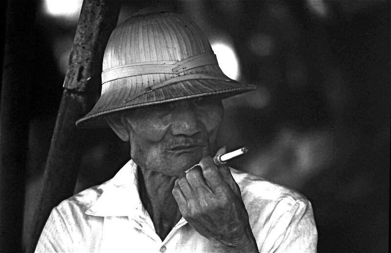 Man in straw hat smoking cigarette