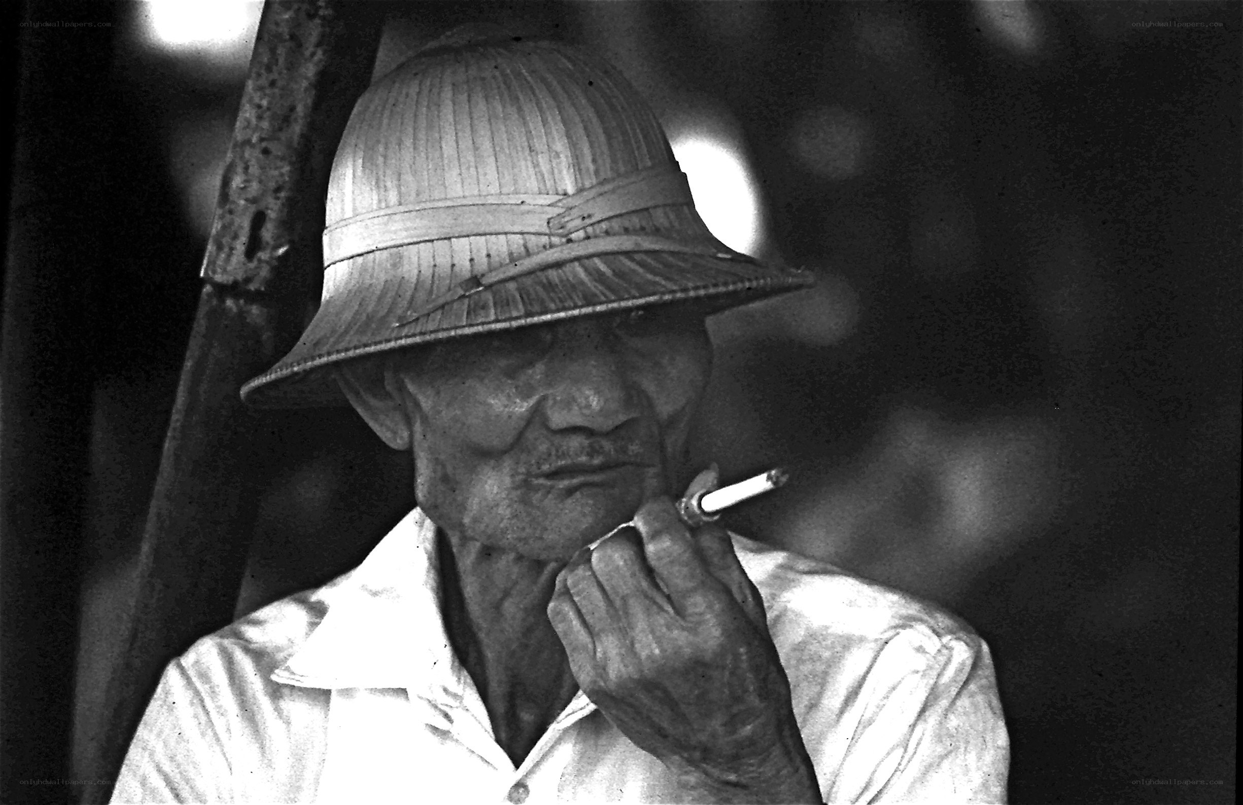 Man in straw hat smoking cigarette