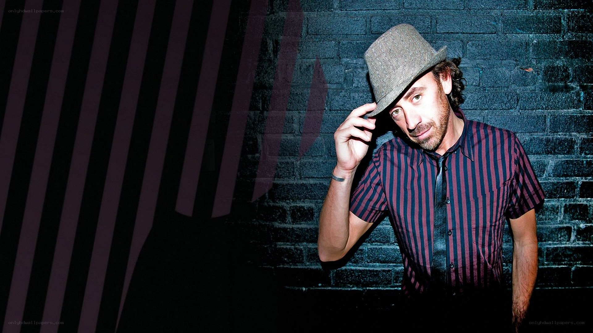 man in striped shirt and hat