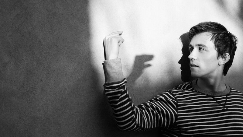man in striped shirt casting shadow