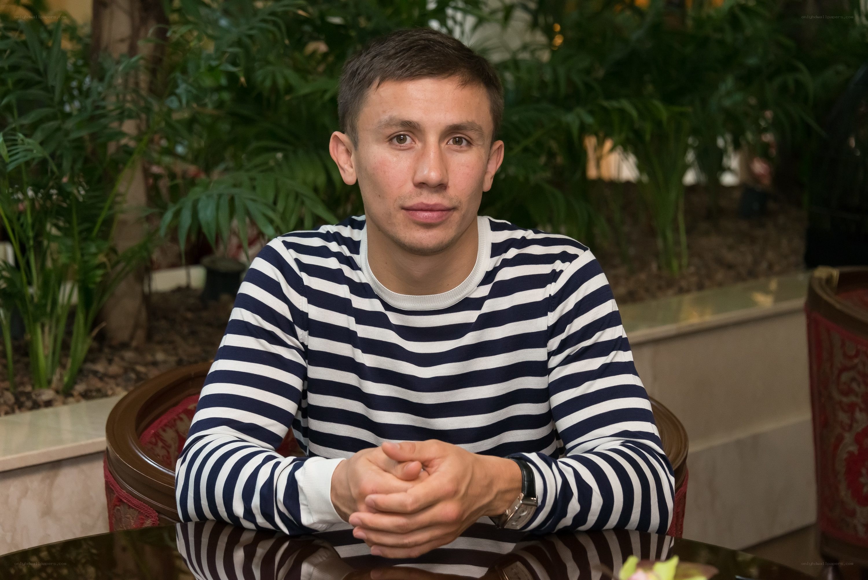 man in striped shirt sitting
