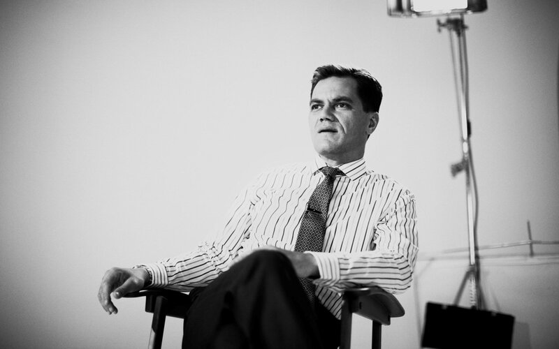 man in striped shirt sitting
