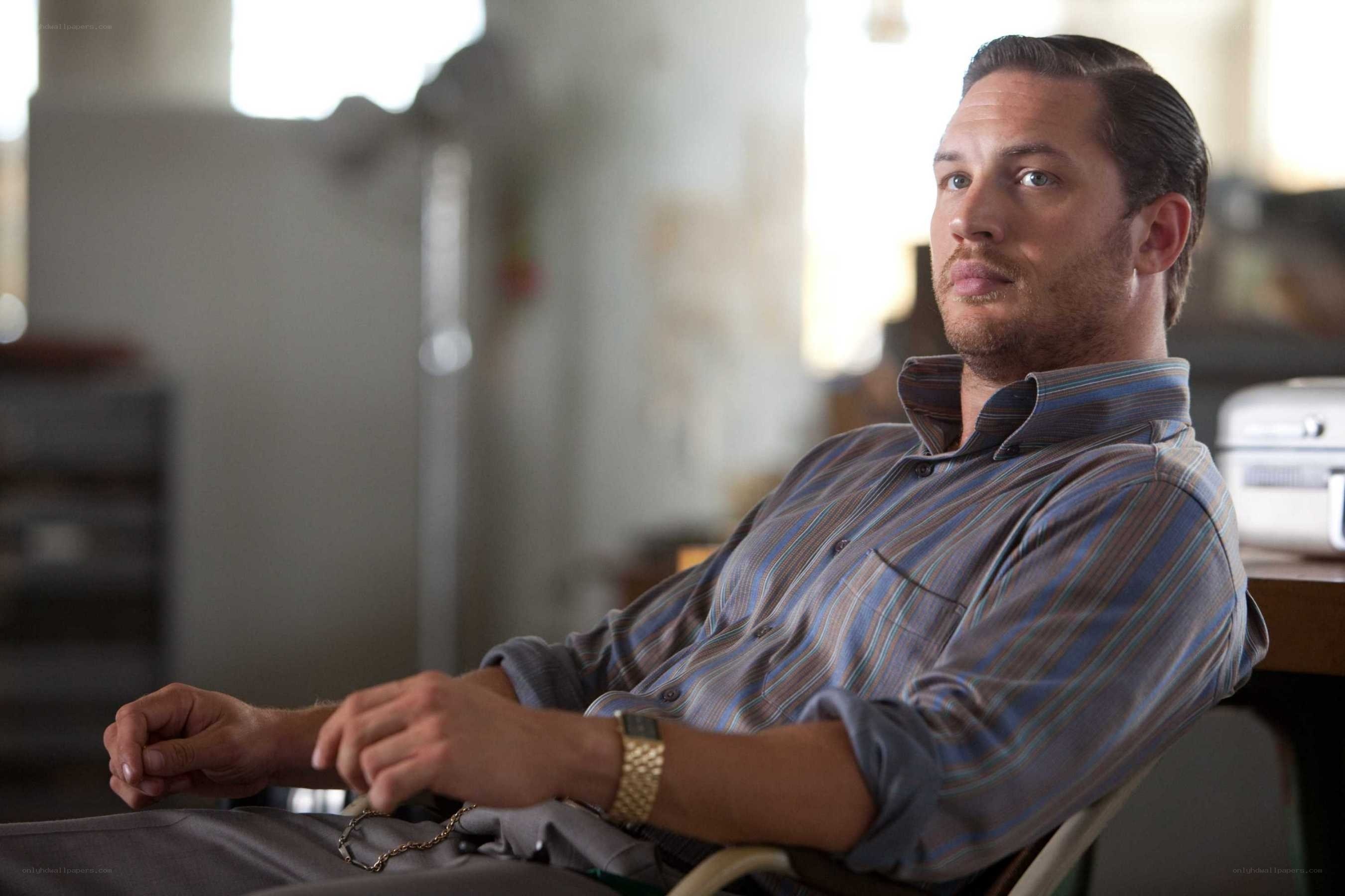 man in striped shirt sitting
