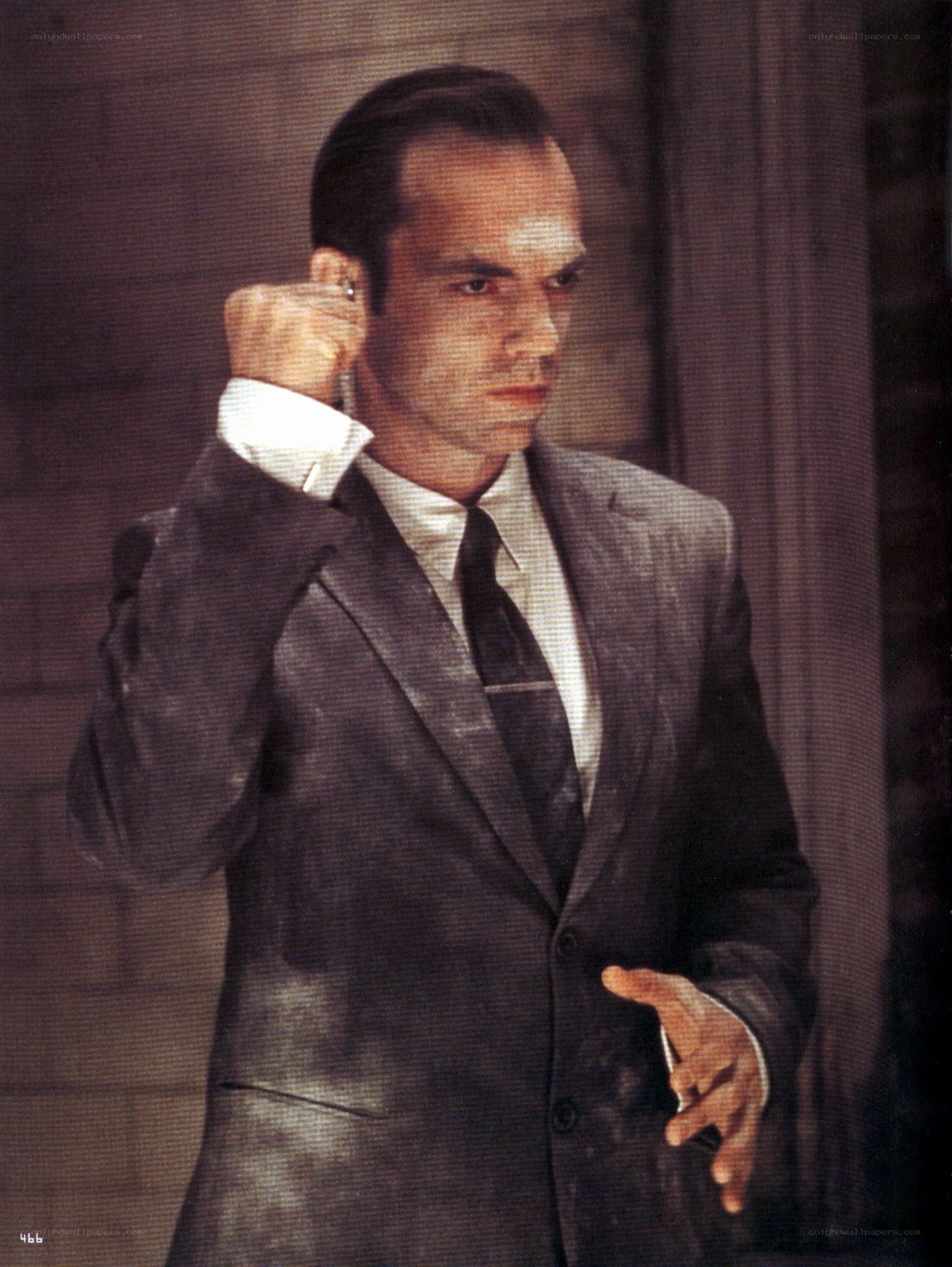 man in suit adjusting earpiece