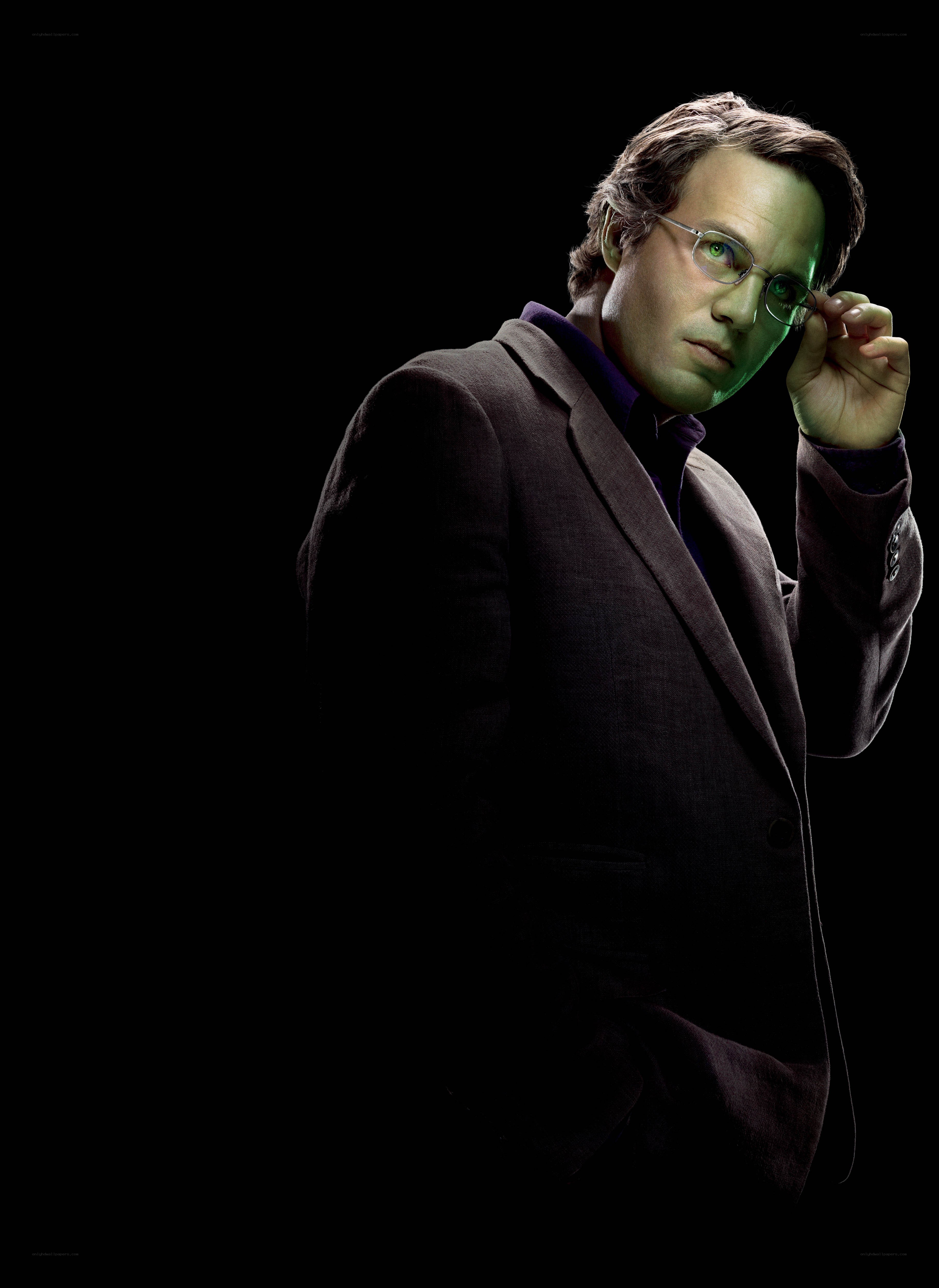 man in suit adjusting glasses