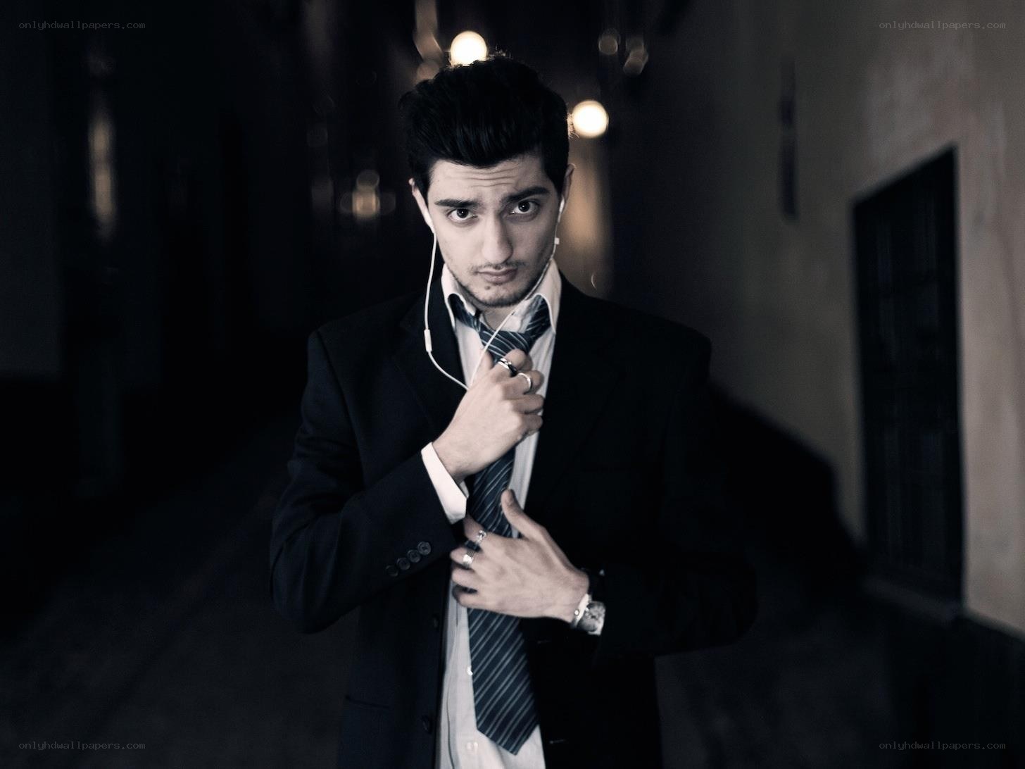 man in suit adjusting tie