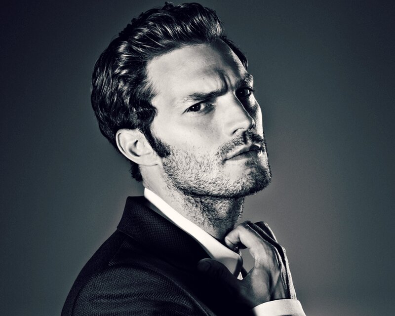 Man in Suit Adjusting Tie — Black, Dramatic