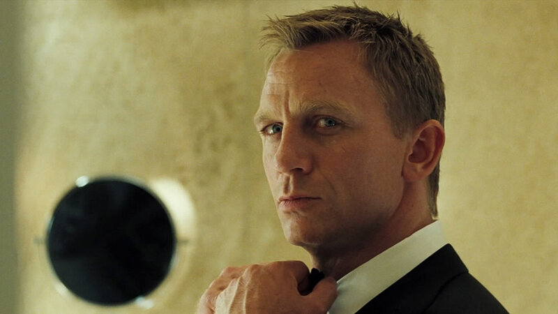 Man in Suit Adjusting Tie — Black, Serious