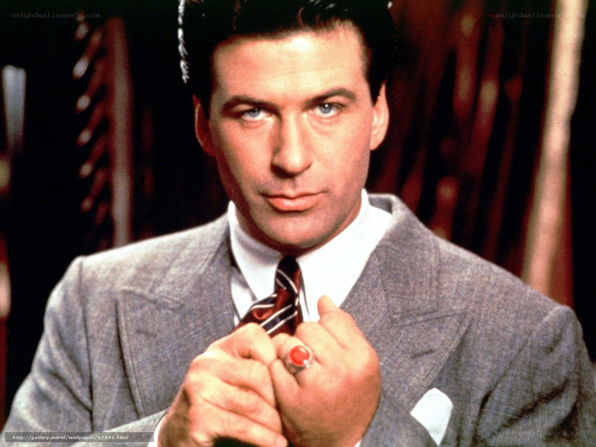 man in suit adjusting tie