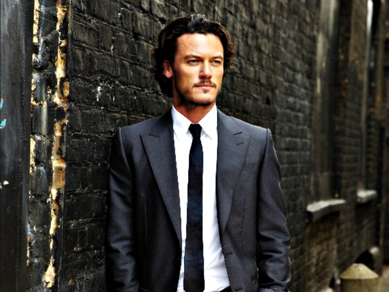 Man in Suit Against Brick Wall — Black