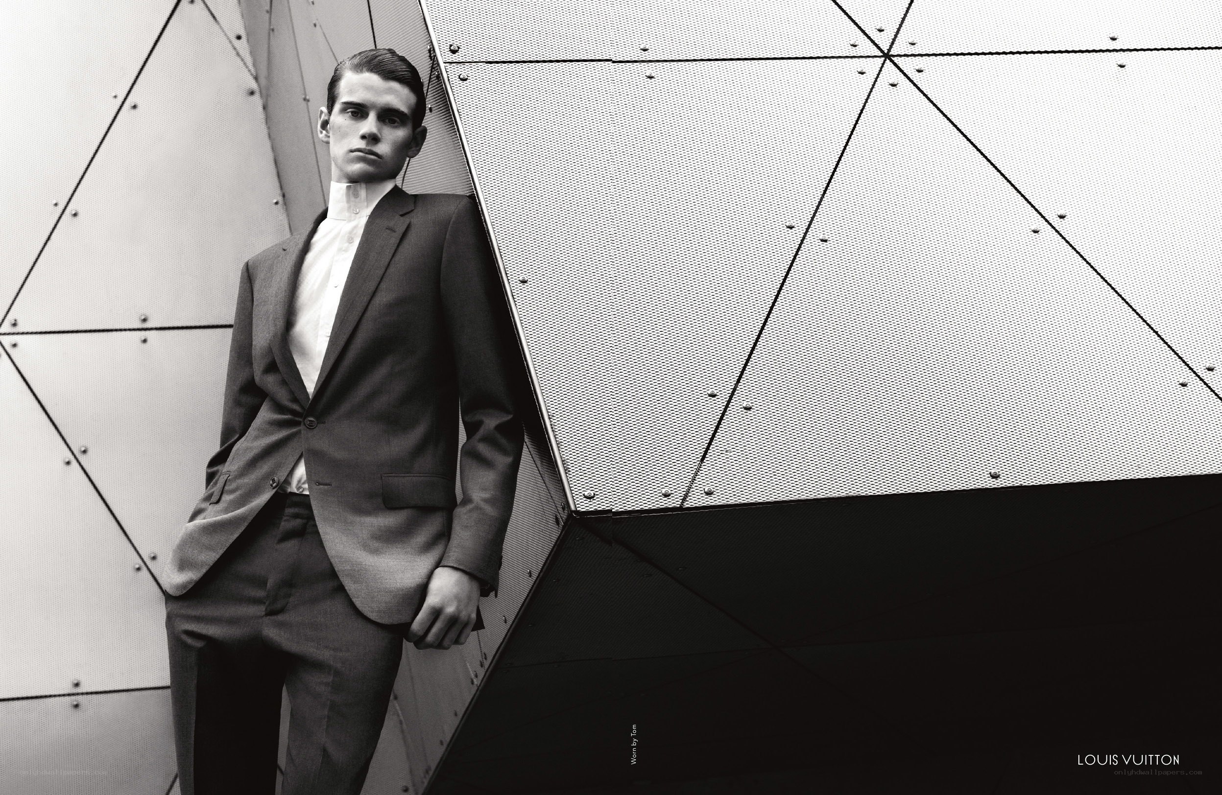 Man in suit against geometric wall