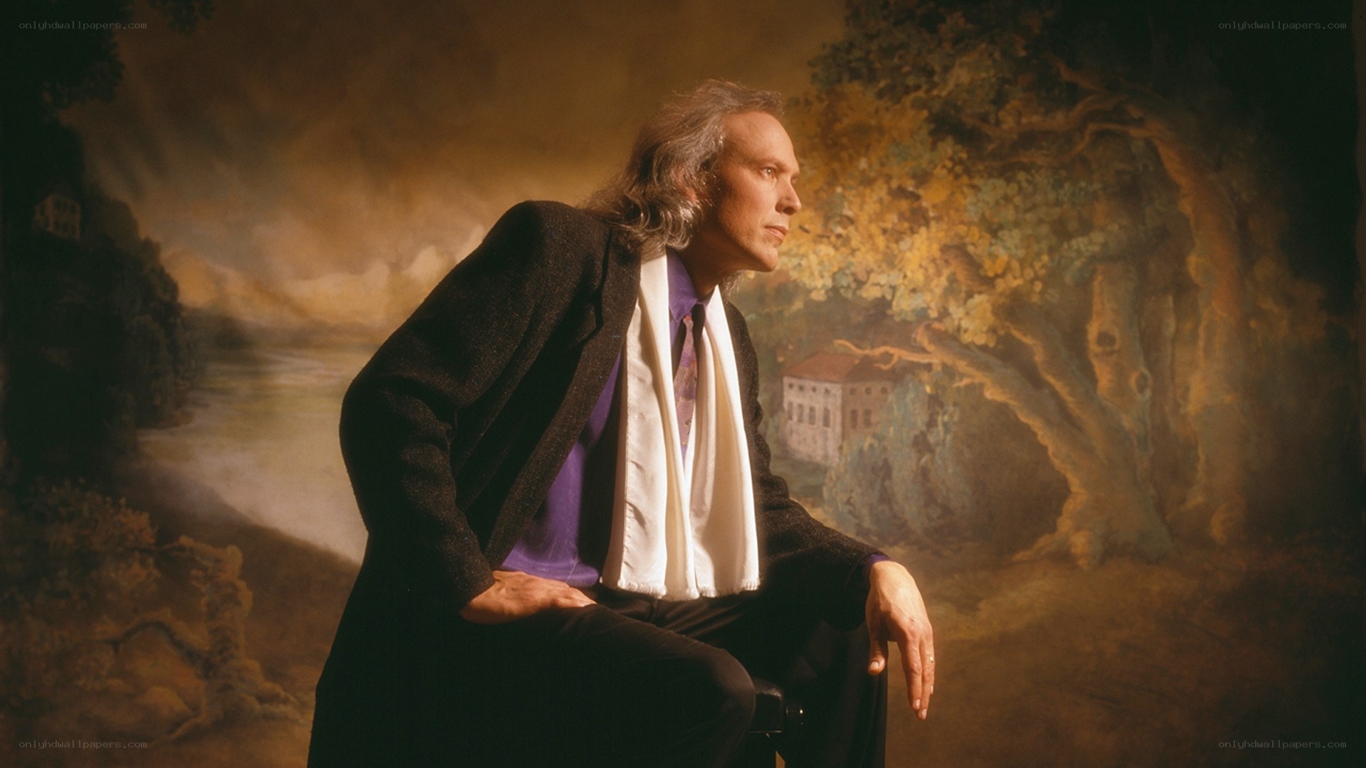 Man in suit against painted backdrop