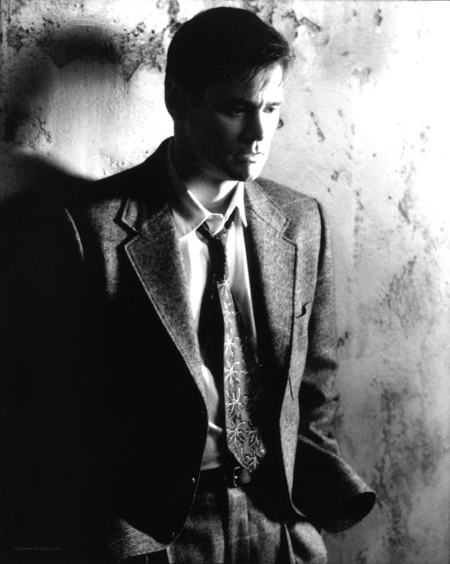 man in suit against wall