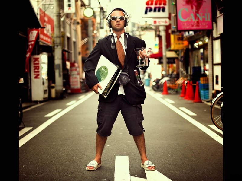 Man in suit and shorts on street
