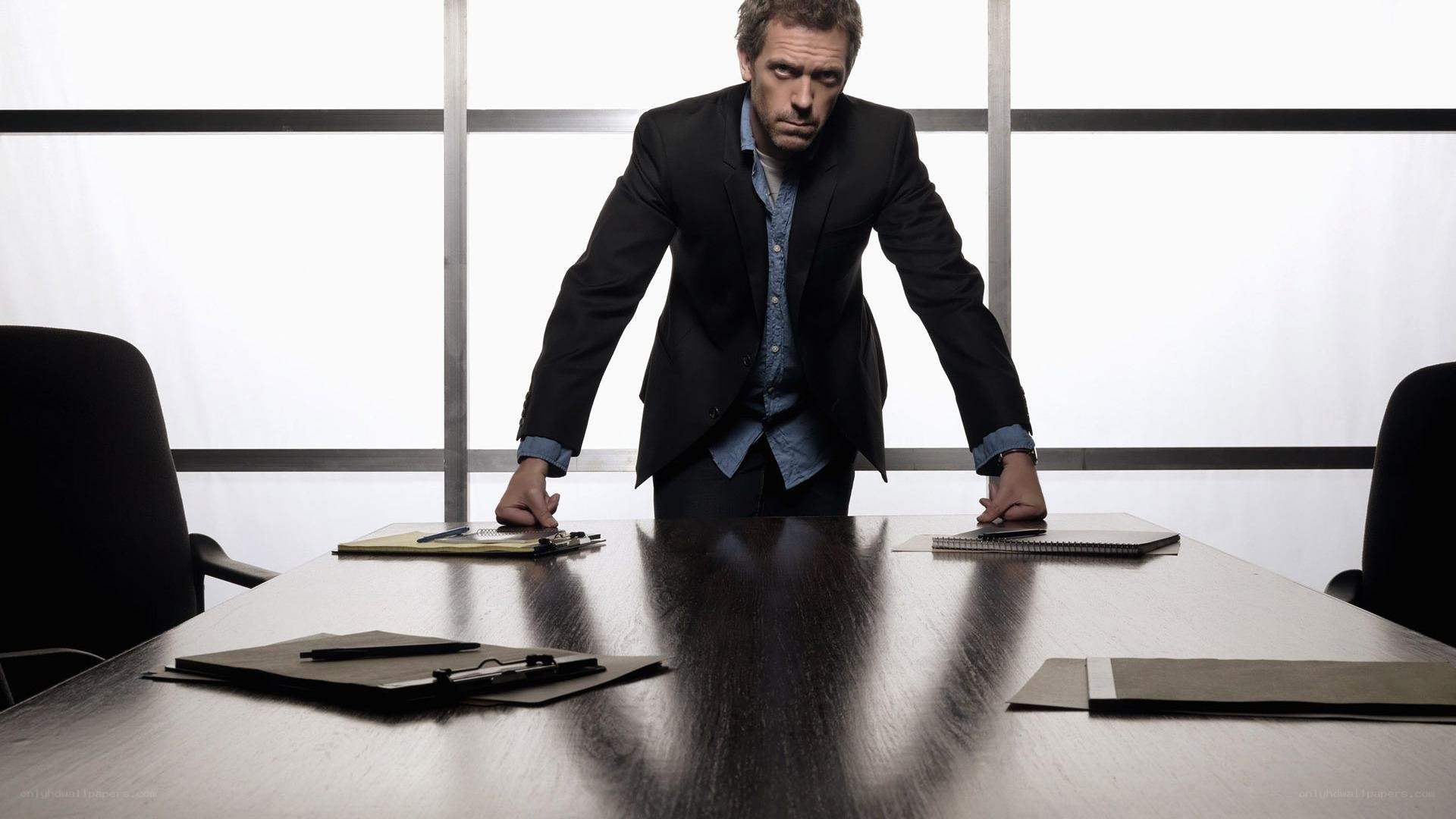 man in suit at conference table