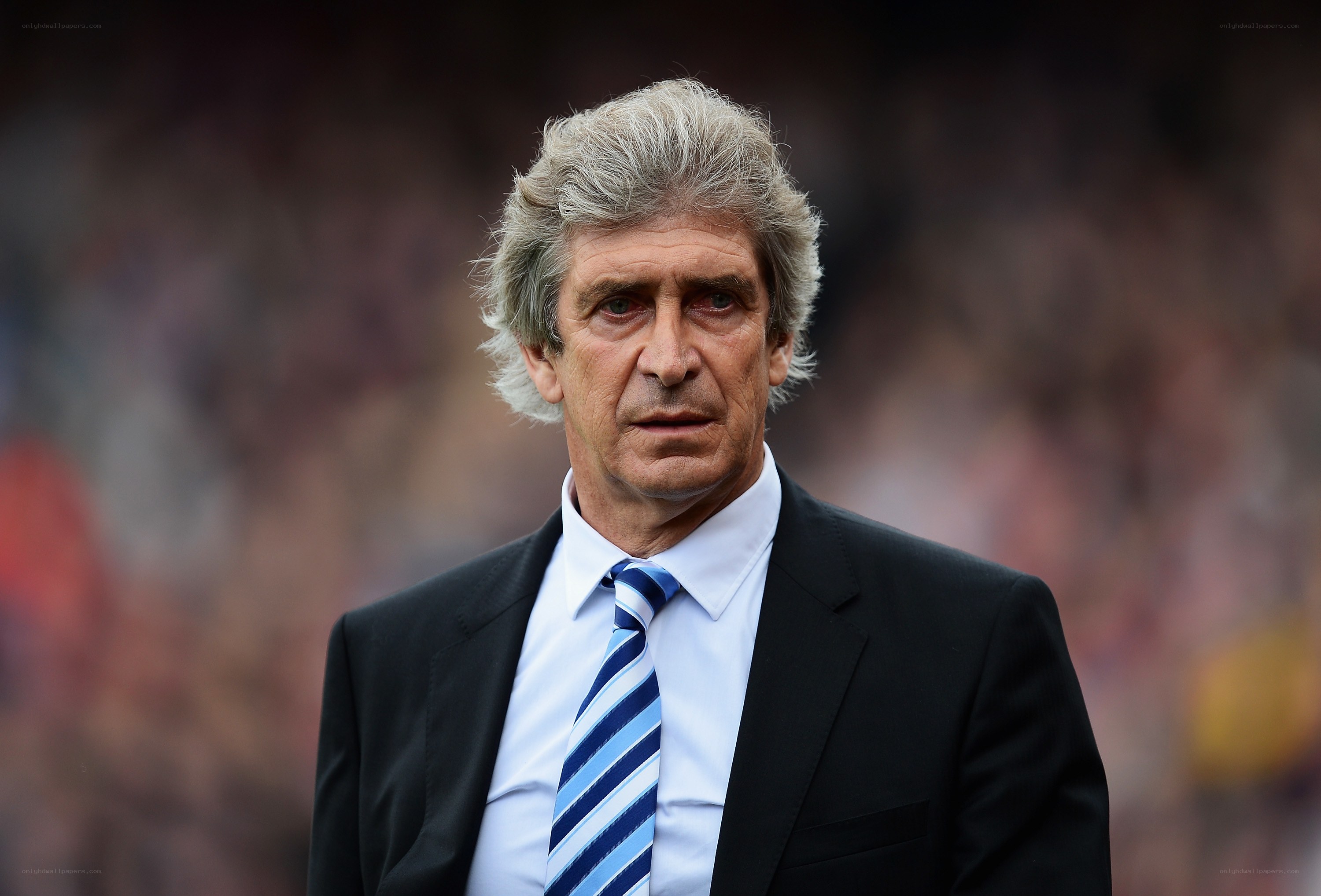 man in suit at stadium