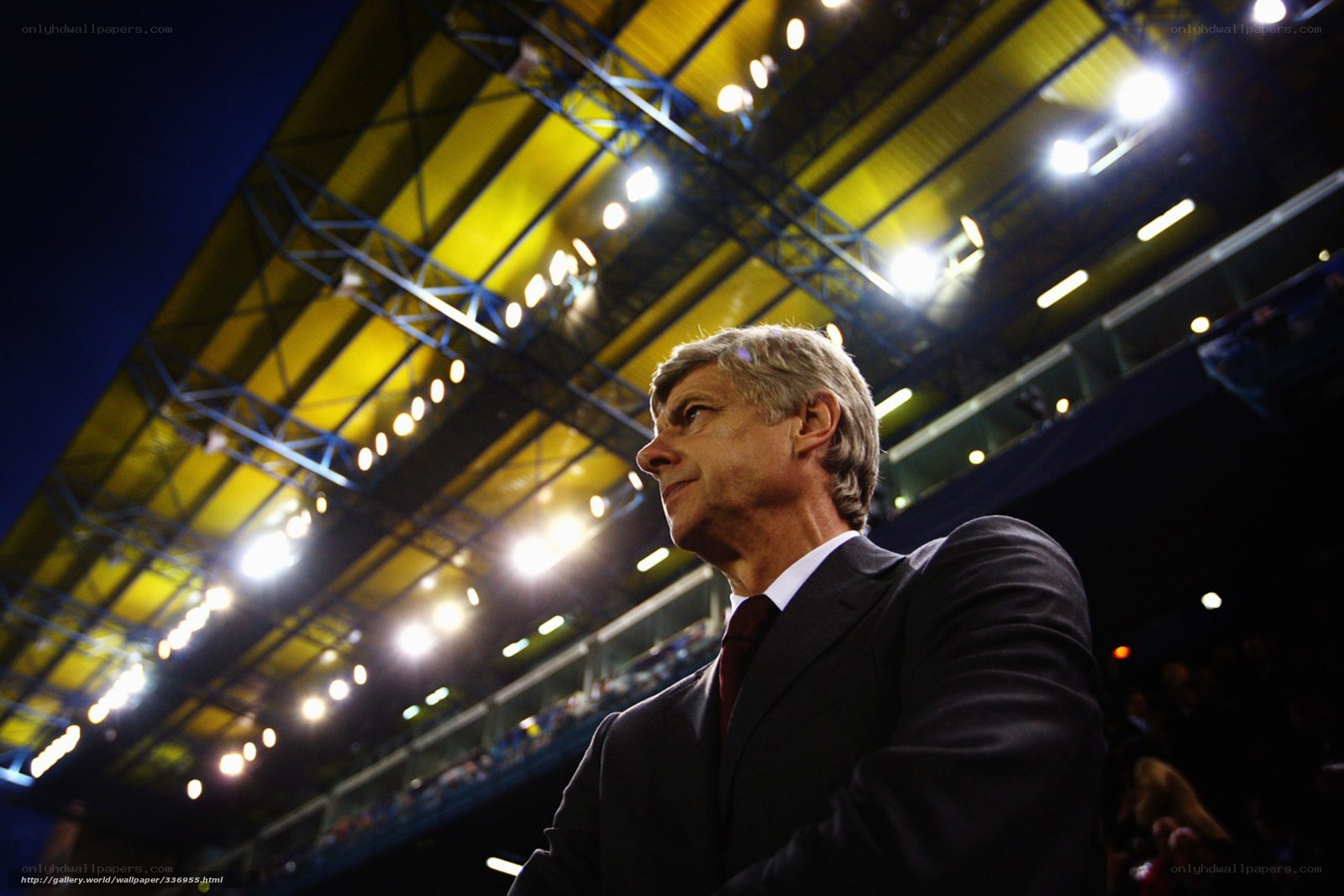 man in suit at stadium