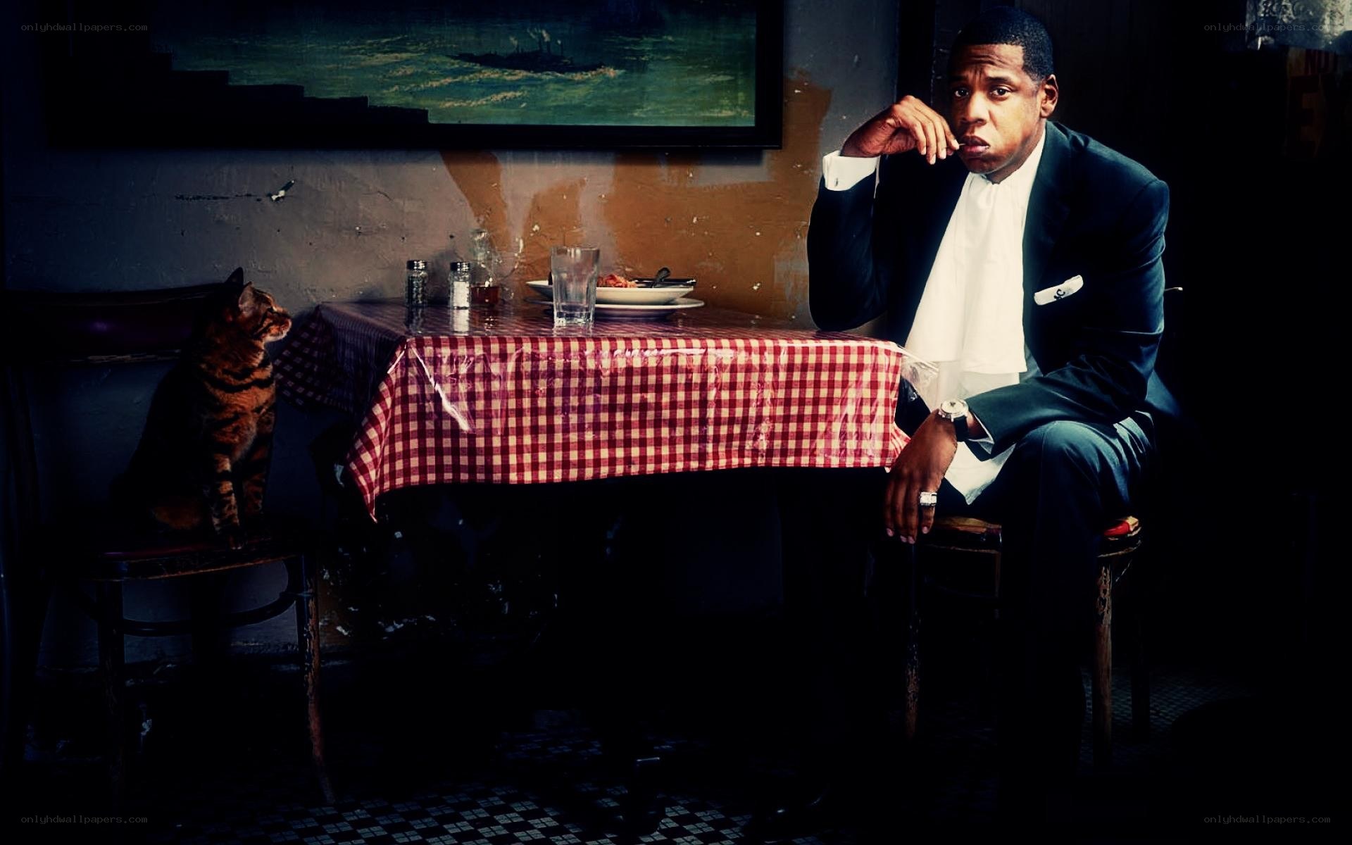 man in suit at table with cat