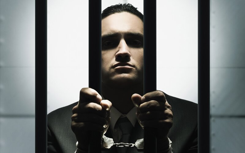 Man in Suit Behind Bars — Black
