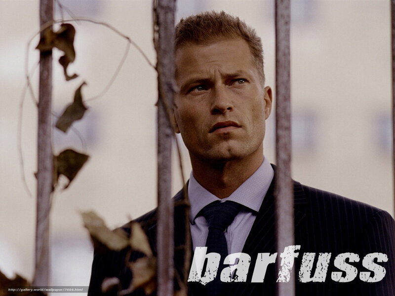 man in suit behind bars