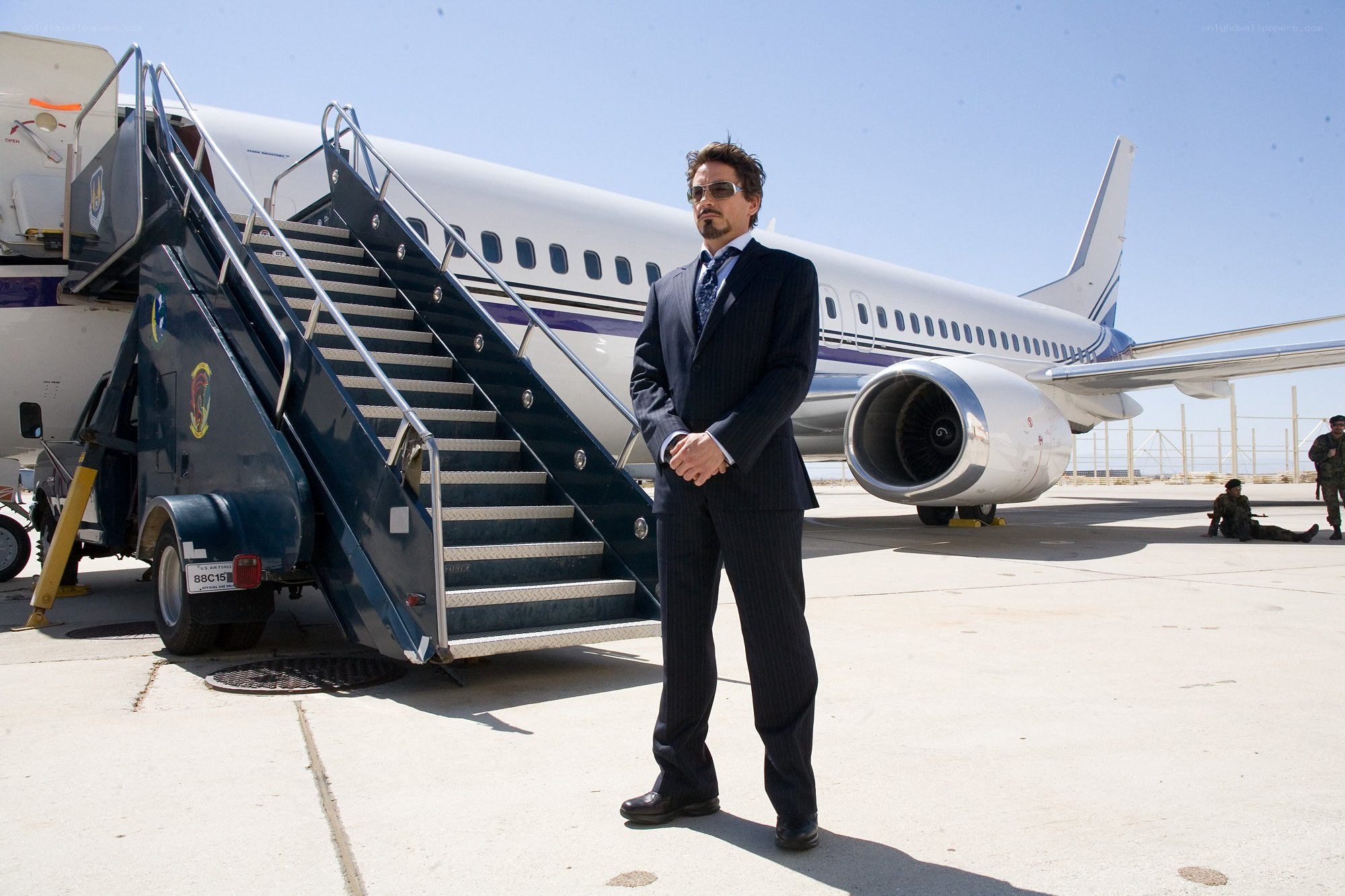 Man in suit by airplane