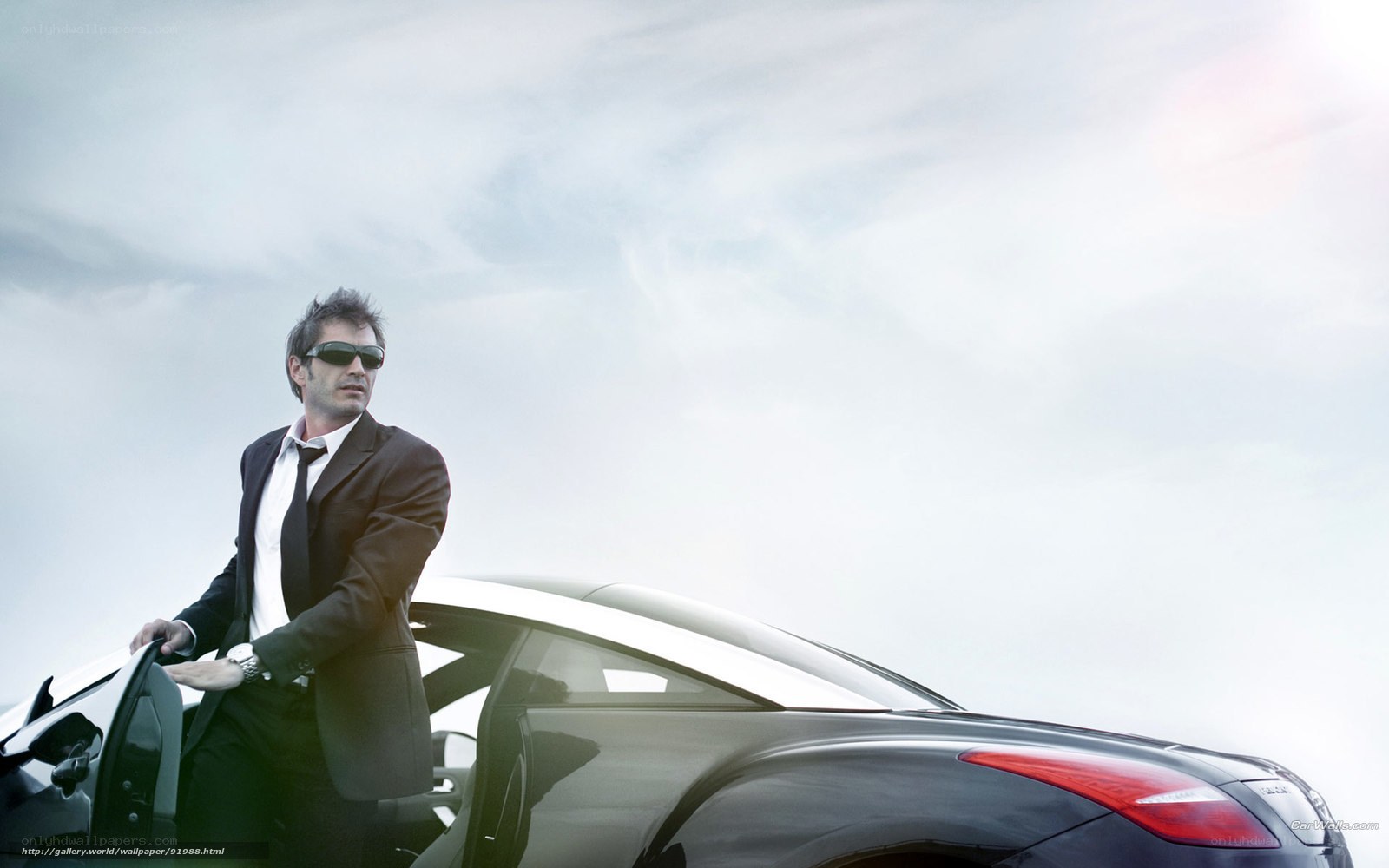 man in suit by car
