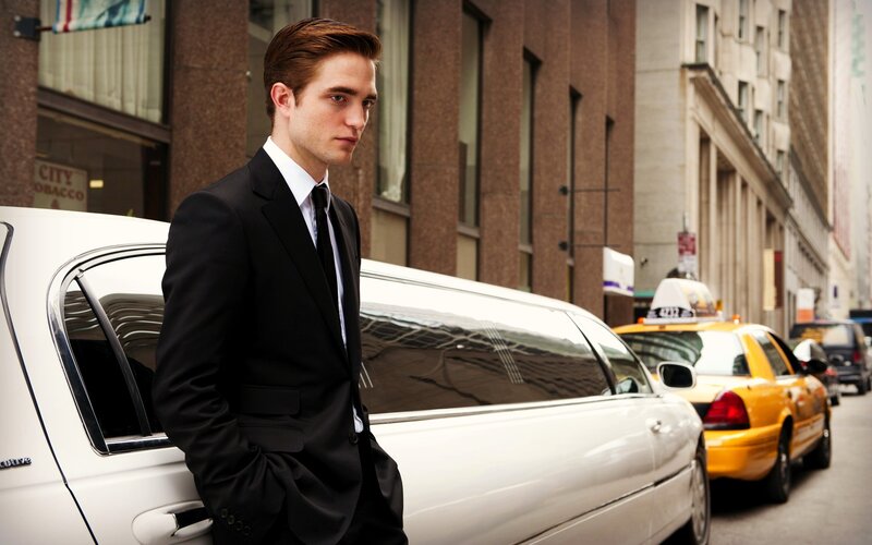 man in suit by limo
