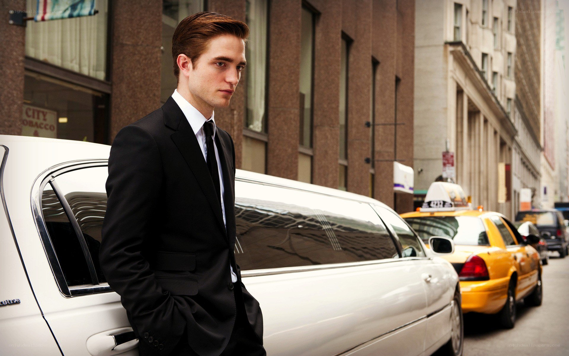 man in suit by limo