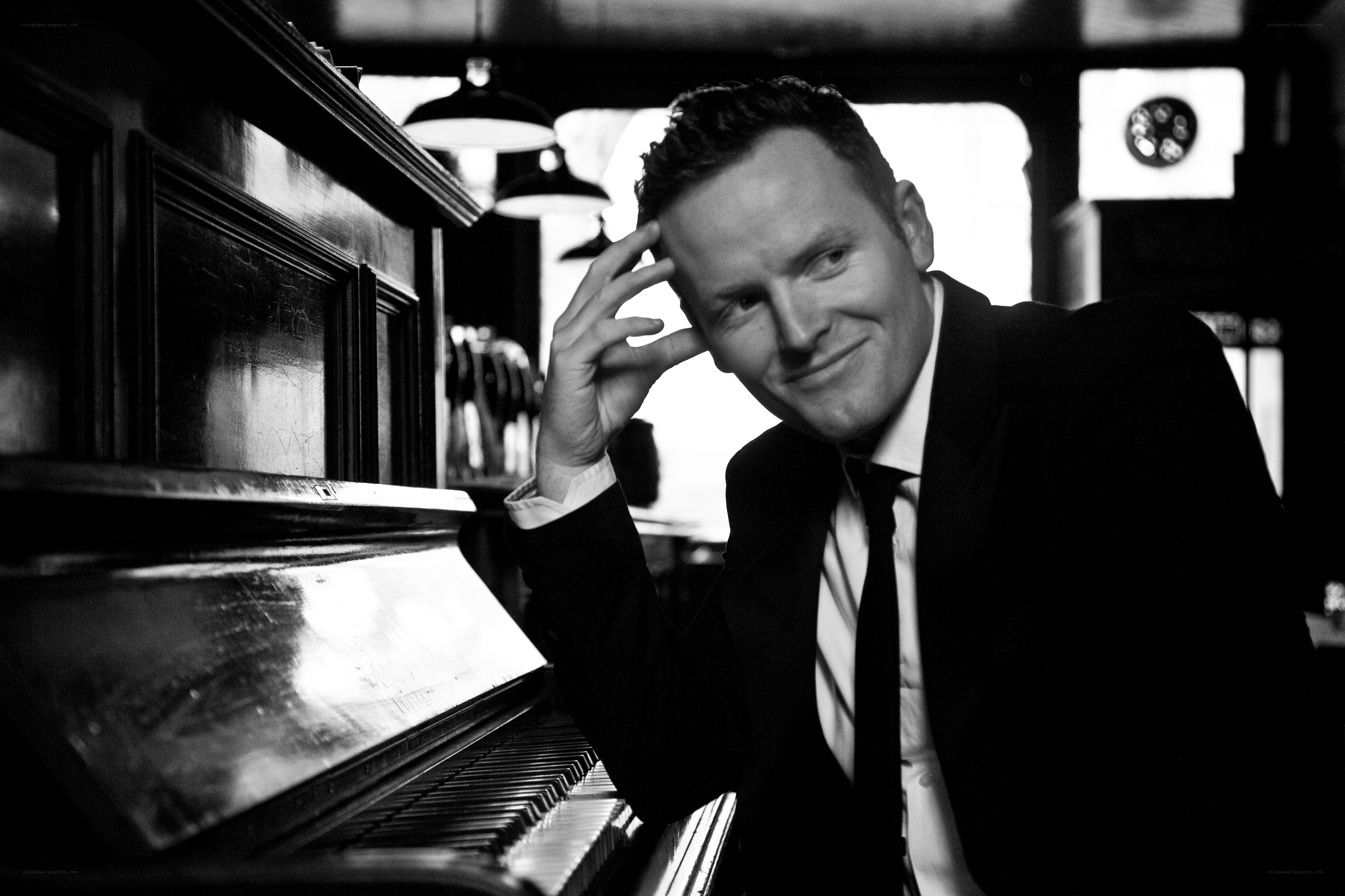 man in suit by piano