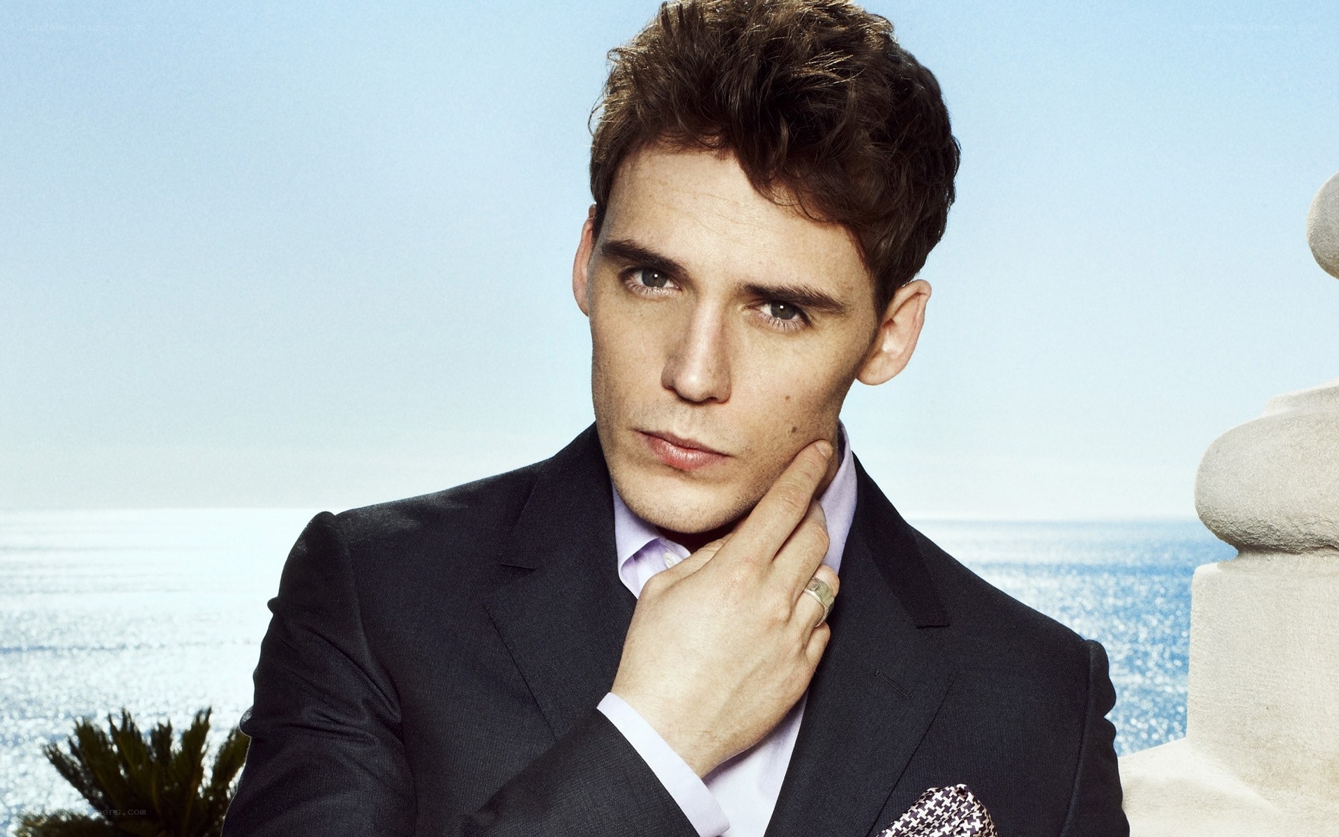 man in suit by the sea
